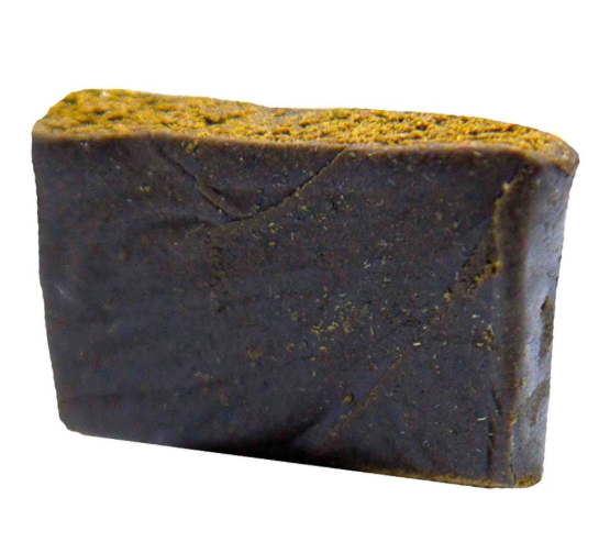 A rectangular bar of dark brown soap with a textured, yellowish-yellow top surface, shown on a plain white background.