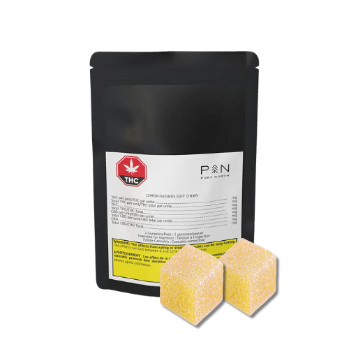 A black package labeled with the brand 'Port North' containing lemon hash infused soft chews, alongside two yellow-colored soft chews outside the package.