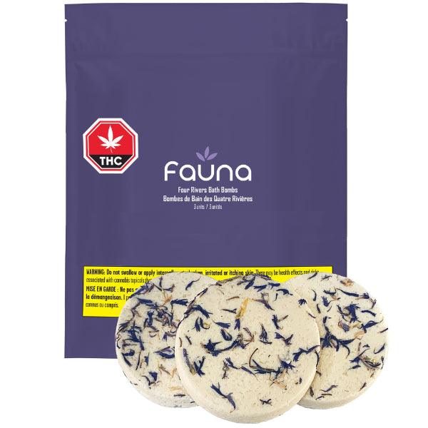 A package of Fauna brand bath bombs, with the product visible in a round shape beside the package. The package is labeled with a THC content warning and has branding elements such as a pine cone illustration.
