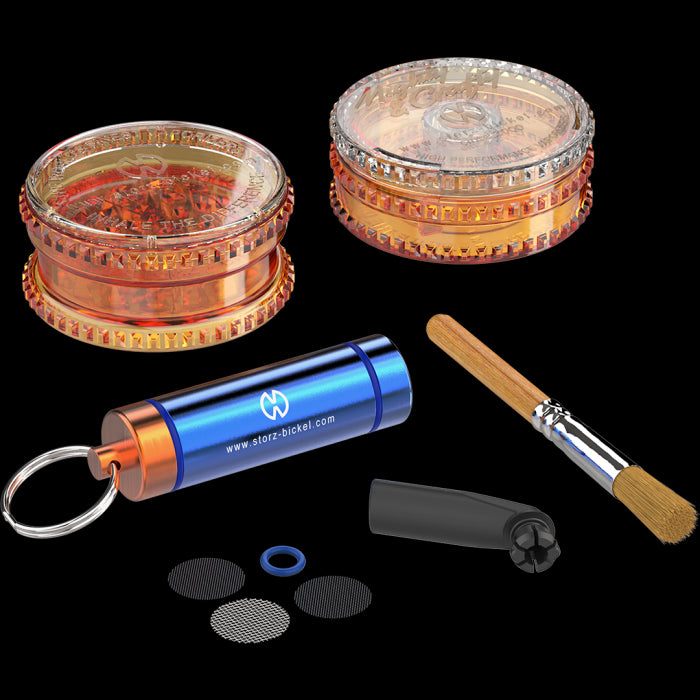 An assortment of vaporizer accessories including a filling aid, herb mill, mouthpiece, seal ring, screens, cleaning brush, and capsule caddy.