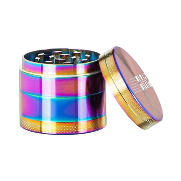 A small rainbow-colored metal grinder with a magnetic cap and multiple compartments, displaying a range of colors including pink, purple, yellow, and green.