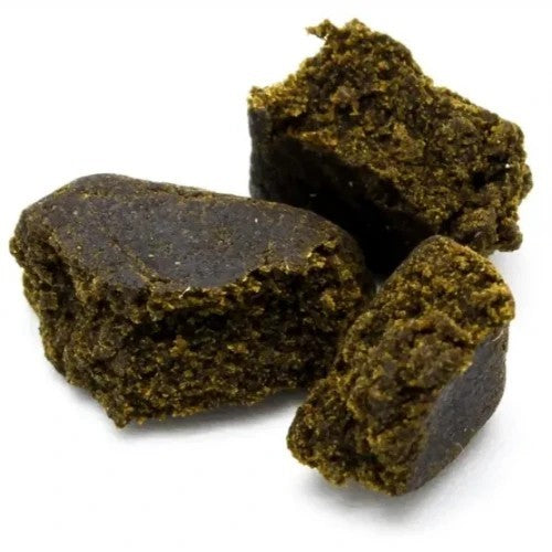 The image displays several pieces of Medisenol Black Afghan Hash Concentrate, recognizable by their distinctive dark green color and compact, irregular shapes. This hash concentrate, known for its potent effects, is often favored for its high content of cannabinoids.