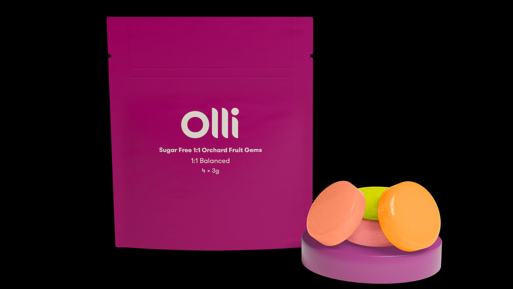 A package of Olli Orchard 1:1 Cannabis Infused Hard Candy with three flavored candies displayed in front of the package.