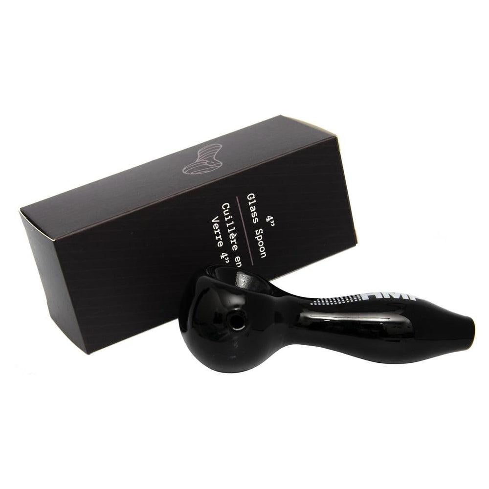 A black glass spoon-style hand pipe, displayed in front of its packaging box which has a small white logo on the top.