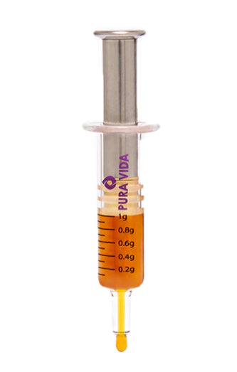 An all-glass honey oil dispenser with a metallic top, marked with measurement lines and branded with 'Pura Vida'.
