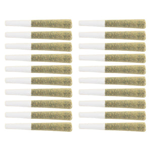 Multiple pre-rolled joints with white paper and green rolling paper on a white background