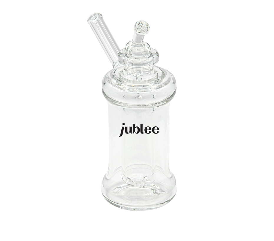 Clear glass bottle with a straw on a white background, featuring the brand 'jublee'.