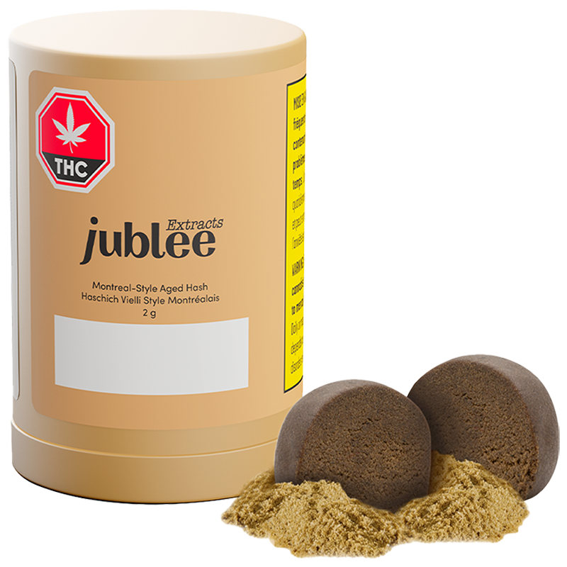 Jublee THC extracts container with two hash rocks and some hash on a white background