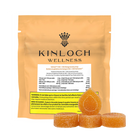 Packaging for Kinloch Wellness CBG + CBD Mango Gummy Drops with three gummy candies in the front. The packaging is primarily orange and gold with product information and branding visible.