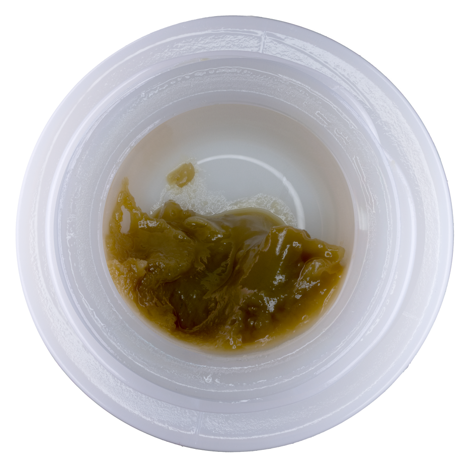 Small container with brownish substance on a white background