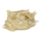 A dollop of creamy, semi-translucent beige balm or wax with a glossy texture, isolated on a solid white background.