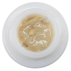 A close-up top-down view of a translucent white circular container filled with a glossy, semi-translucent beige cream or balm.