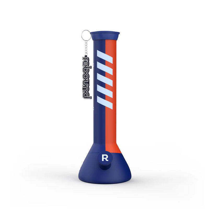 A silicone beaker-style water pipe with blue and red stripes on a blue base, featuring a glass bowl and the brand name 'Rebound' on the side.