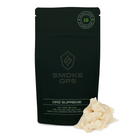 A black stand-up pouch labeled SMOKE OPS ORZ SUPREME with a small pile of pale cream-colored wax or resin in front, shown on a plain white background.