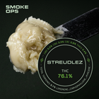 A spoonful of creamy off-white cannabis balm or wax on a black background, with a circular label reading STREUDLEZ THC 76.1% and green text including CBD, CBG, CBN, THC, and terpene details.