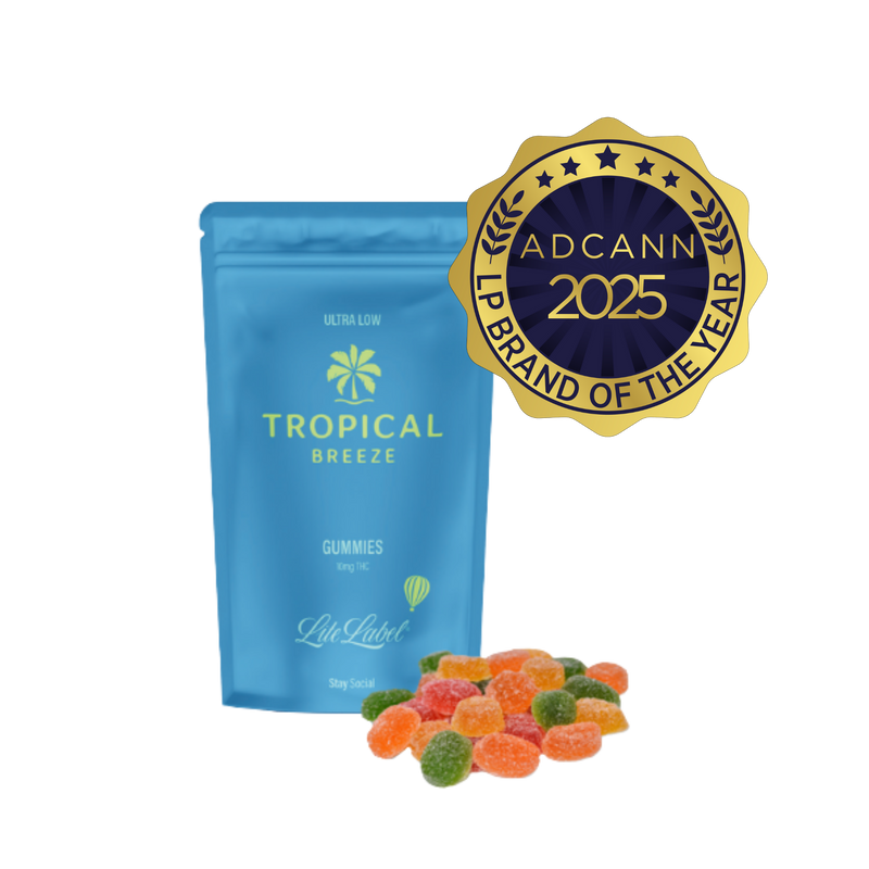 Blue package of 'Tropical Breeze' gummies with a gold ADCANN 2025 brand award on a white background
