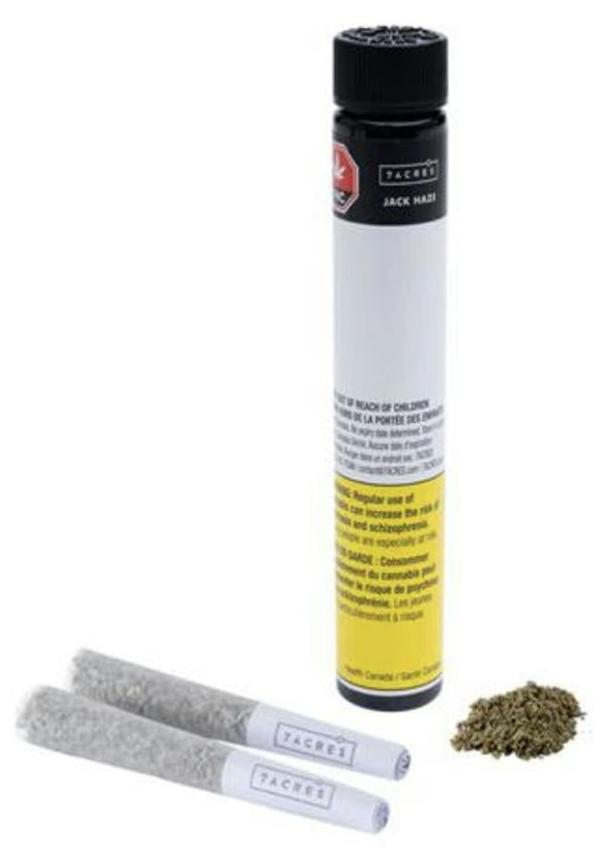 Packaging of 7ACRES Jack Haze pre-rolled joints with visible branding, dosage information, and a small pile of ground cannabis beside it.