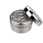 A silver dosing capsule with a filling pad inside, designed for gap filler use with finely ground herbs.
