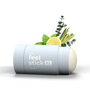 Feel Stick XL product with herbs and lemon on a white background