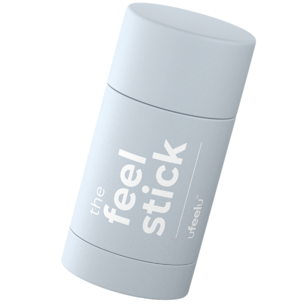 A stick-shaped topical ointment with the text 'the feel stick' printed on its body, predominantly in a light grey color.