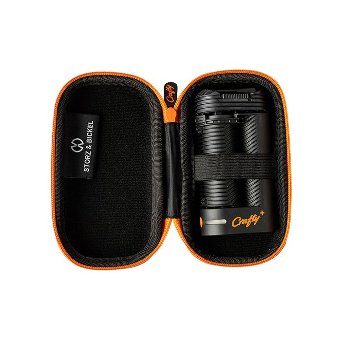 A black and orange Storz & Bickel Crafty travel case with a hard shell and a zipper open to show Crafty product in the case 