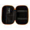 A black and orange Storz & Bickel Mighty Travel Case for carrying smoking devices and accessories that is open featuring compartments and secitons