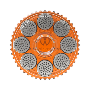 A clear orange magazine with silver dosing capsules designed for filling and storing ground herbs, featuring the Storz & Bickel logo.