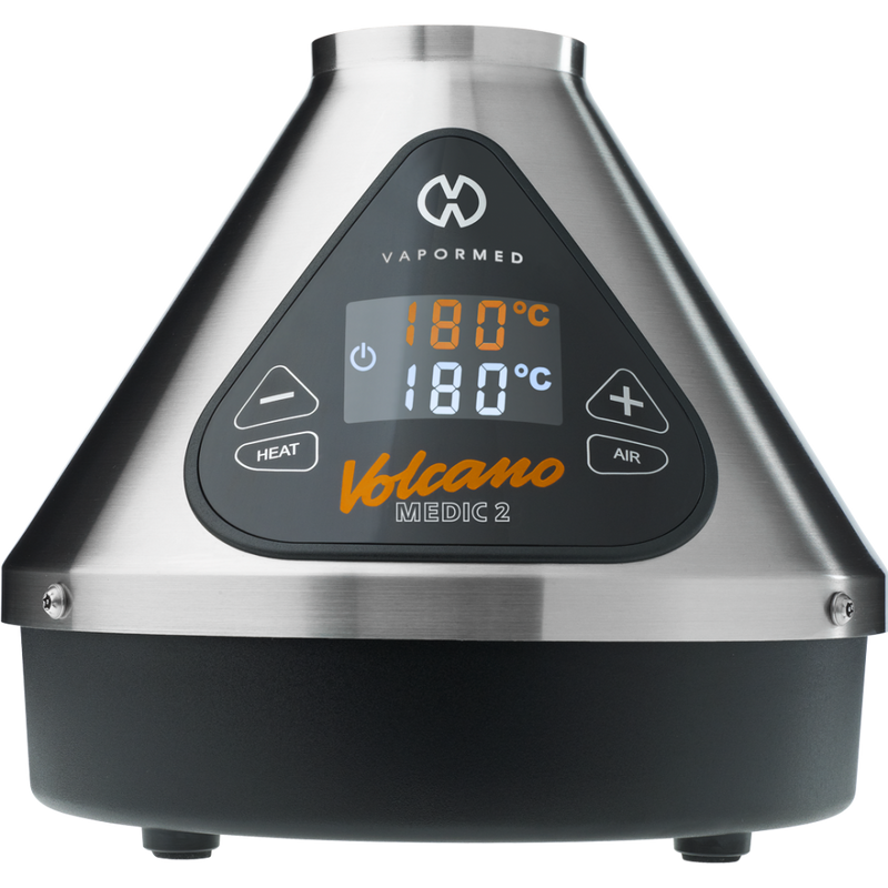 The image shows the Volcano Medic 2 hot air generator, which is a triangular-shaped device with a digital display, touch buttons, and ports for connecting accessories such as balloons and tubes.