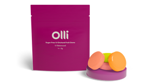 A package of Olli Orchard 1:1 Cannabis Infused Hard Candy with three flavored candies displayed in front of the package.