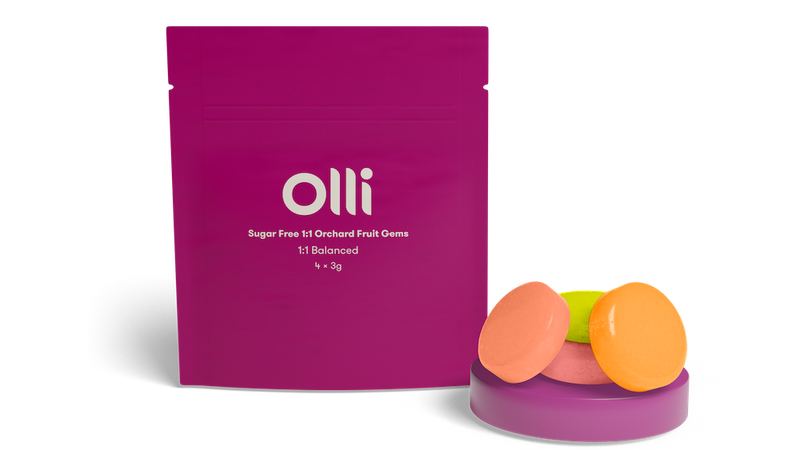A package of Olli Orchard 1:1 Cannabis Infused Hard Candy with three flavored candies displayed in front of the package.
