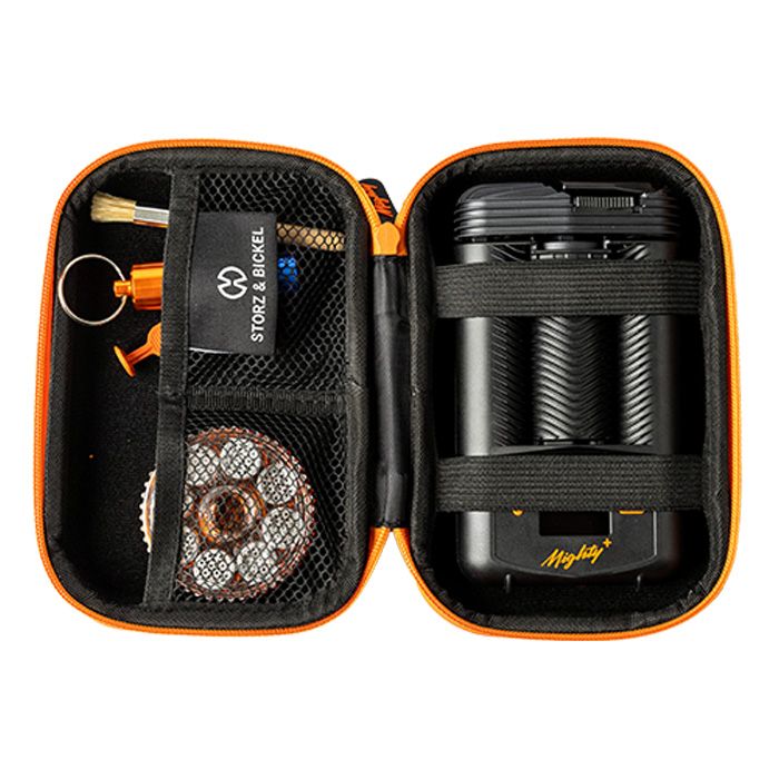 A black and orange Storz & Bickel Mighty Travel Case for carrying smoking devices and accessories showing how your devices can be stores