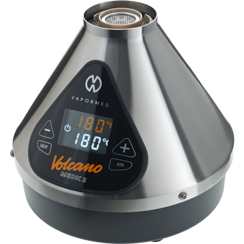 The image shows the Volcano Medic 2 hot air generator, which is a triangular-shaped device with a digital display, touch buttons, and ports for connecting accessories such as balloons and tubes.